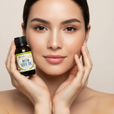 Bottle of Neem seed oil with a black cap on a white background