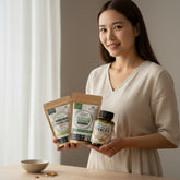 Person holding three health supplement packages on a neutral background