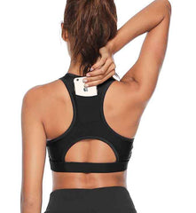 Woman wearing a black sports bra and shorts set on a white background