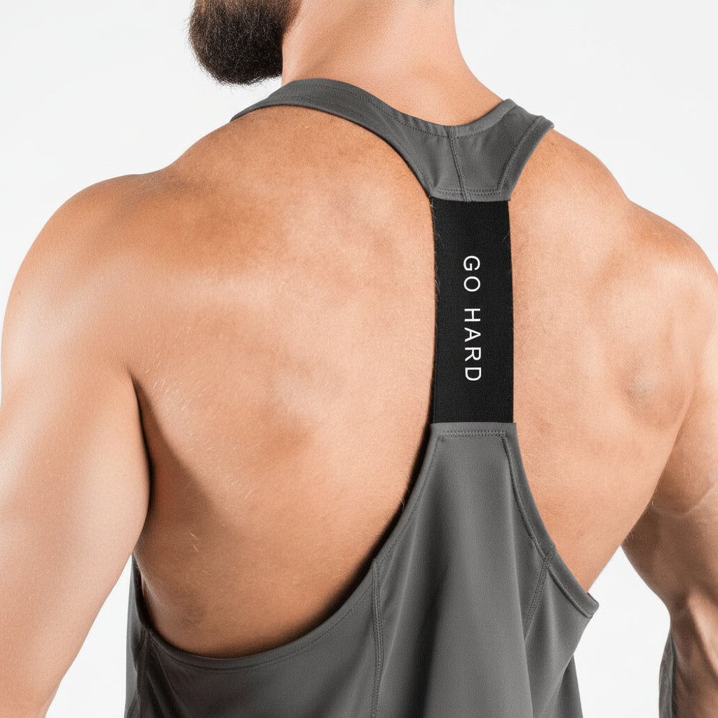 Person wearing a gray tank top with 'GO HARD' text on a white background