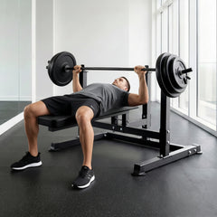 Black weight bench with barbell in a gym setting