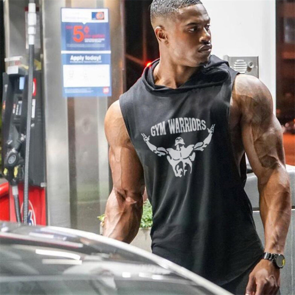 Man wearing a black sleeveless hoodie with 'Gym Warriors' logo at a gas station.